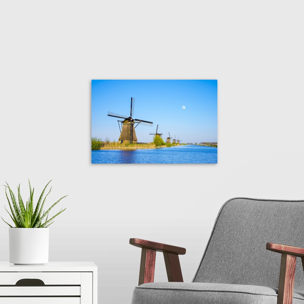 A modern room featuring Netherlands, South Holland, Kinderdijk, UNESCO World Heritage Site. The moon rises above historic...
