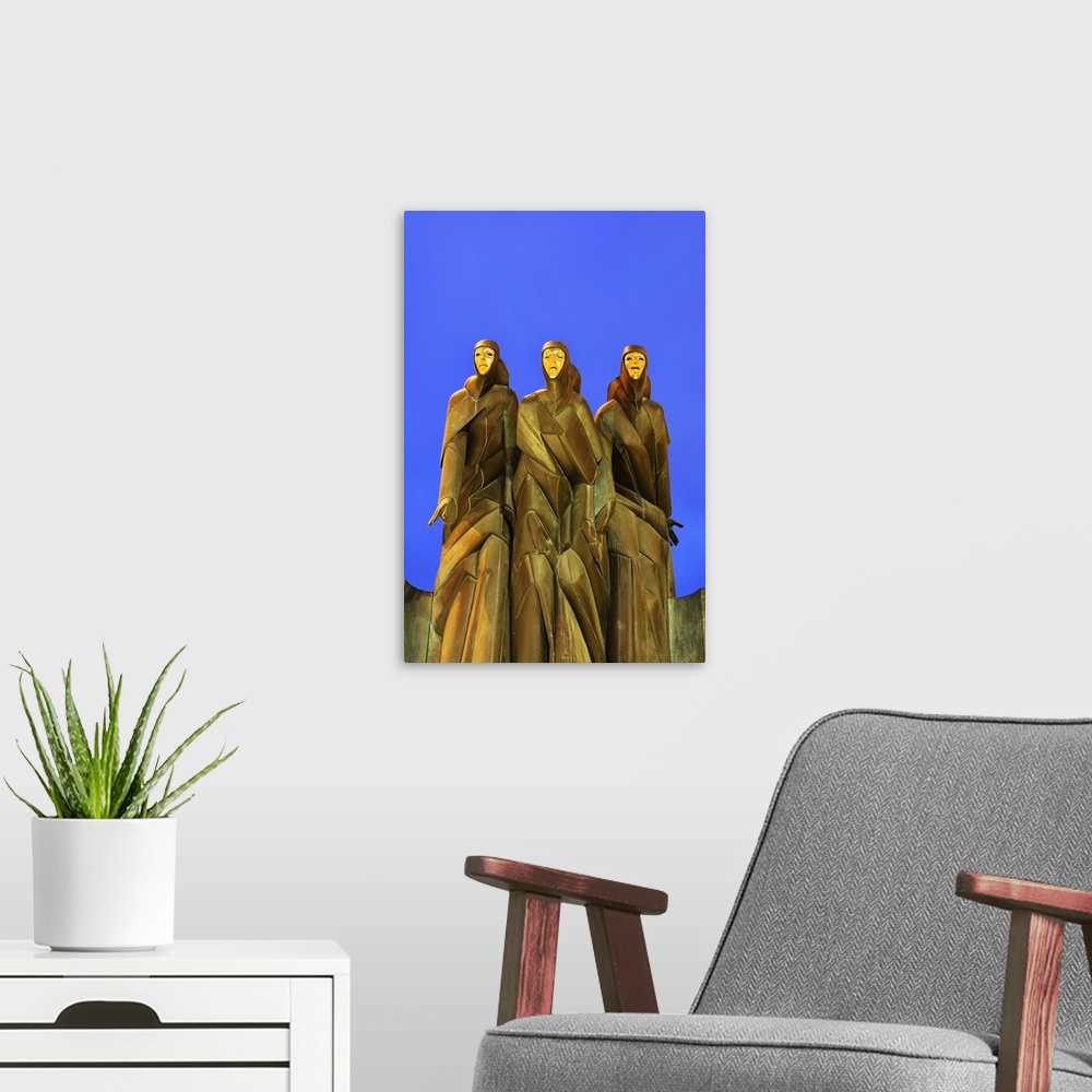A modern room featuring The sculpture Three Muses by Stanislovas Kuzma crowning the main entrance to the National Drama T...