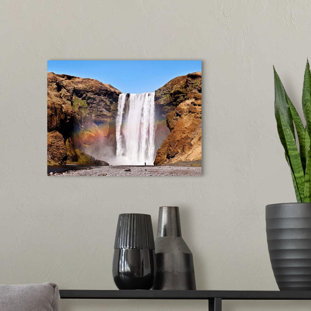 A modern room featuring The Skogafoss, one of the biggest waterfalls in the country with a width of 25 meters and a drop ...