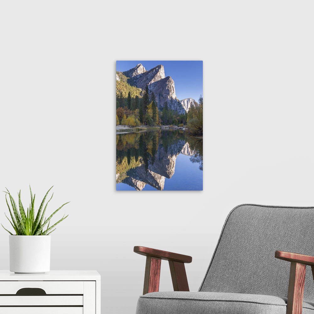 A modern room featuring The Three Brothers reflected in the Merced River at dawn, Yosemite Valley, California, USA. Autum...
