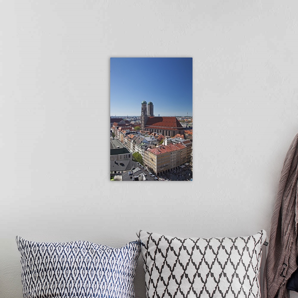 A bohemian room featuring The twin towers of the Munich Frauenkirche and the Marianplatz viewed from the steeple of St. Pet...