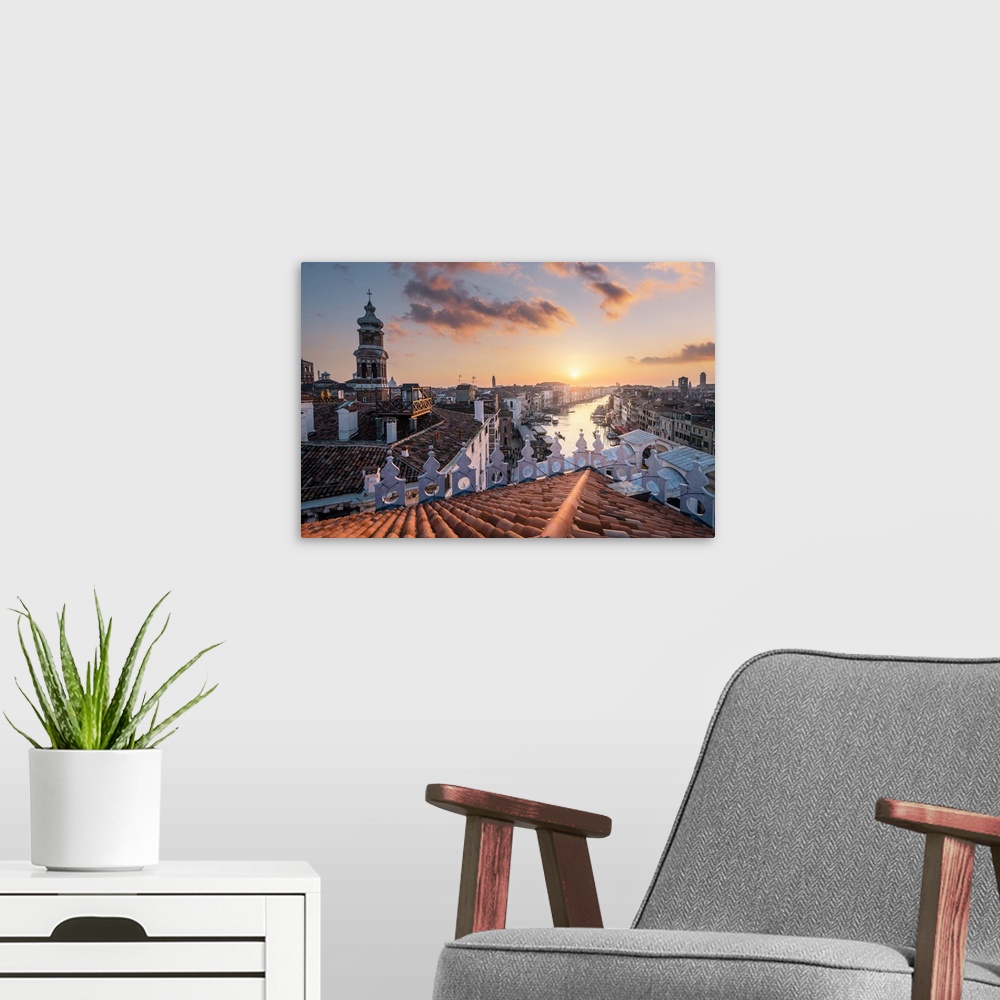 A modern room featuring The view of Canal Grande and Rialto bridge from Fondaco dei Tedeschi, during sunset. Venice, Vene...