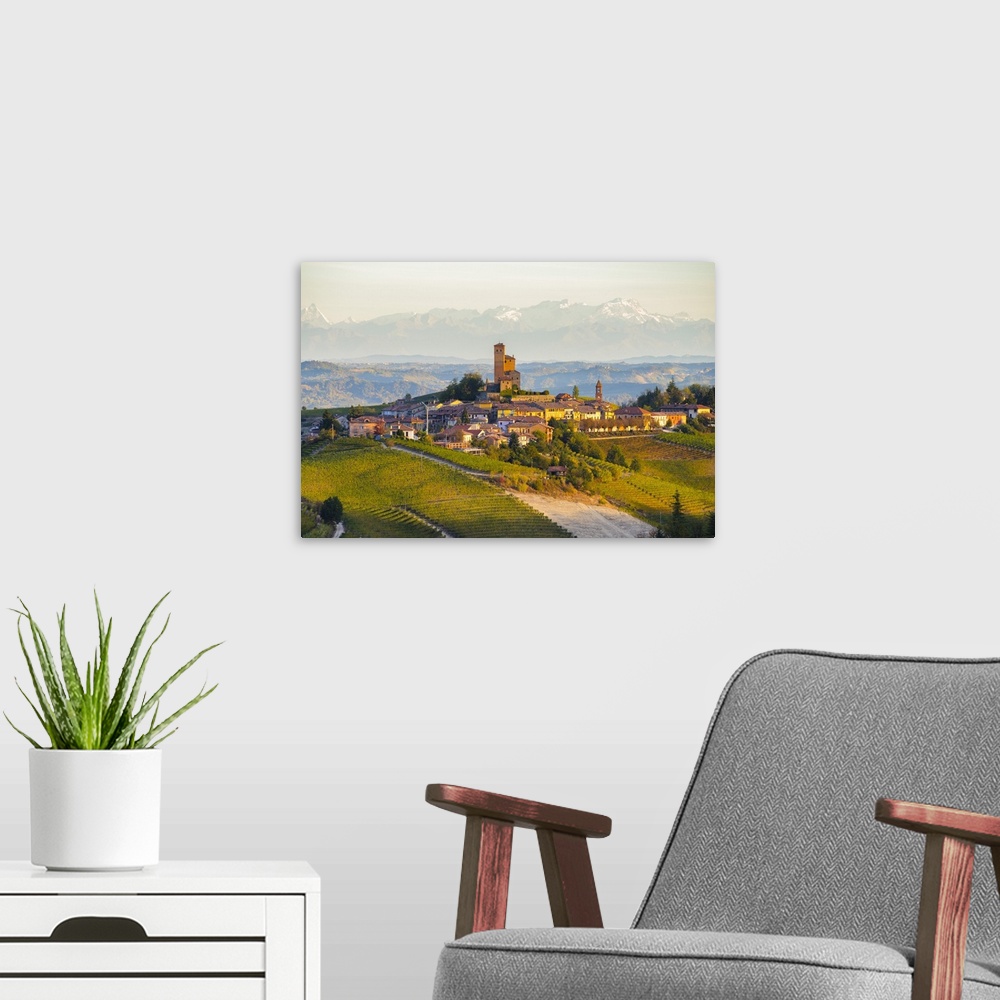 A modern room featuring The vineyards of Serralunga d'Alba and Alps in background during autumn sunrise, Serralunga d'Alb...