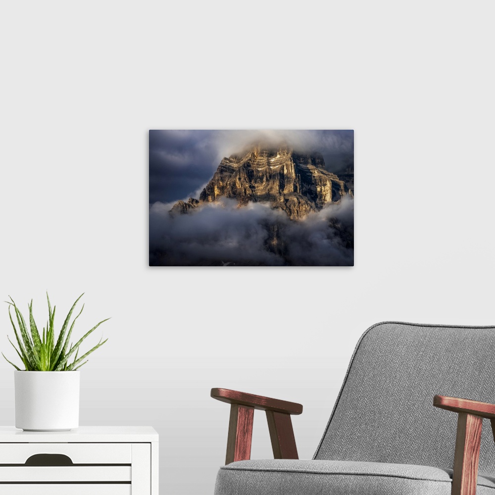 A modern room featuring The walls of Mt. Pelmo in the Italian Dolomites hit by the golden light during a clearing storm i...