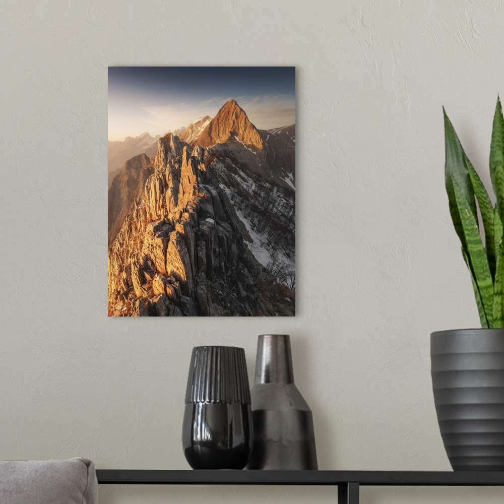 A modern room featuring The warm light of the sunset hit the Mt. Macina and the Apuan Alps during winter, Tuscany, Italy.