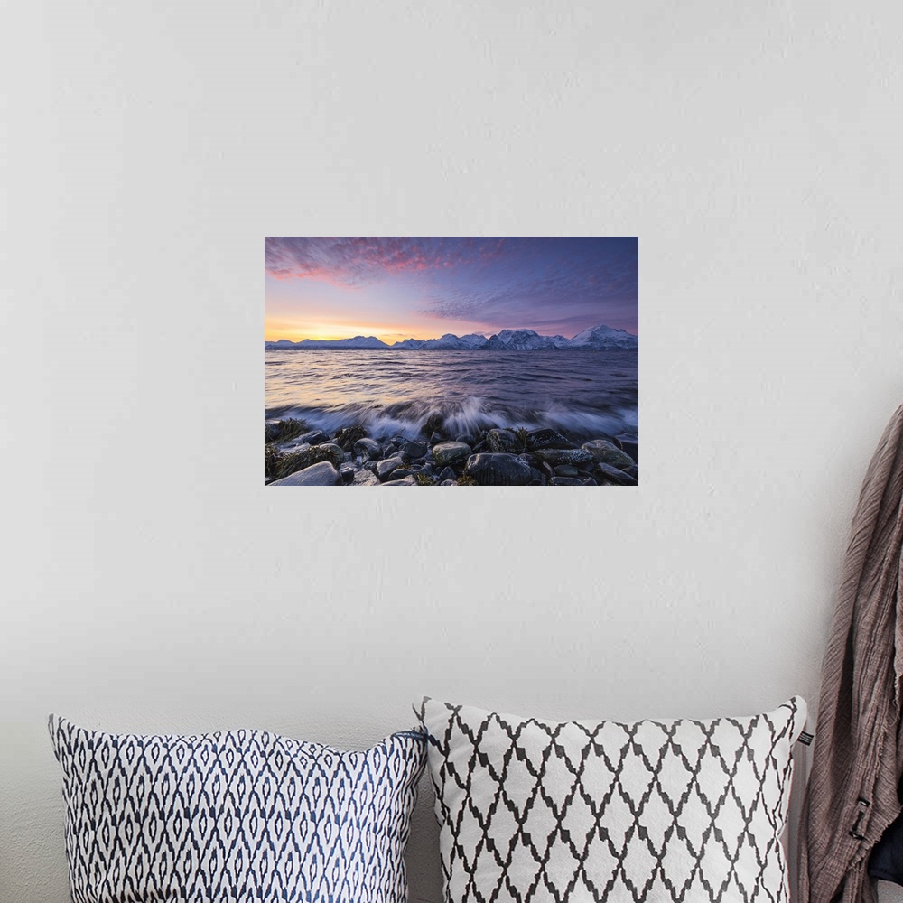 A bohemian room featuring The waves breaking on the stones beach during sunset. Nordmannvik, Kafjord, Lyngen Alps, Troms, N...