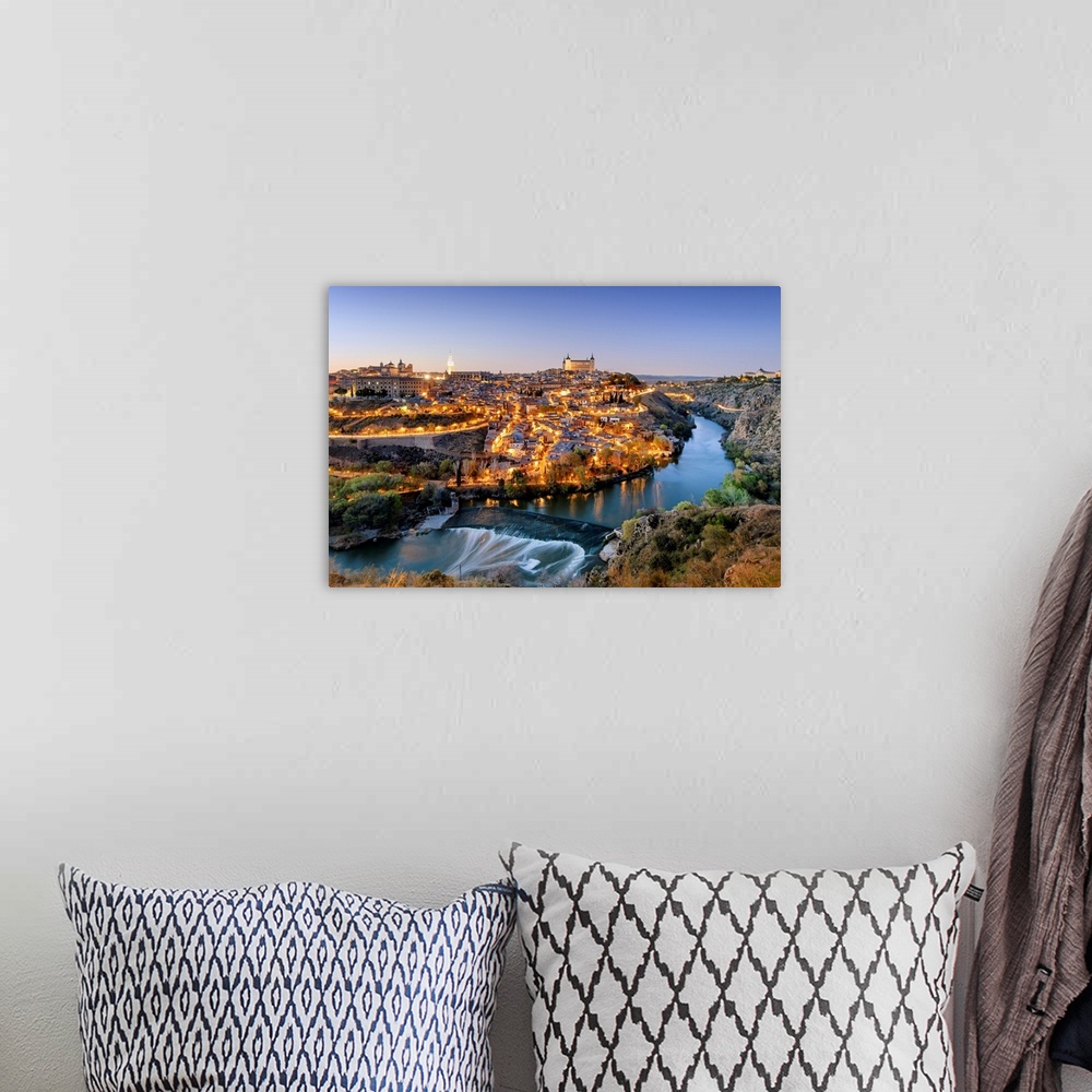A bohemian room featuring Toledo and the Tagus river at twilight, a UNESCO World Heritage Site. Castilla la Mancha, Spain.