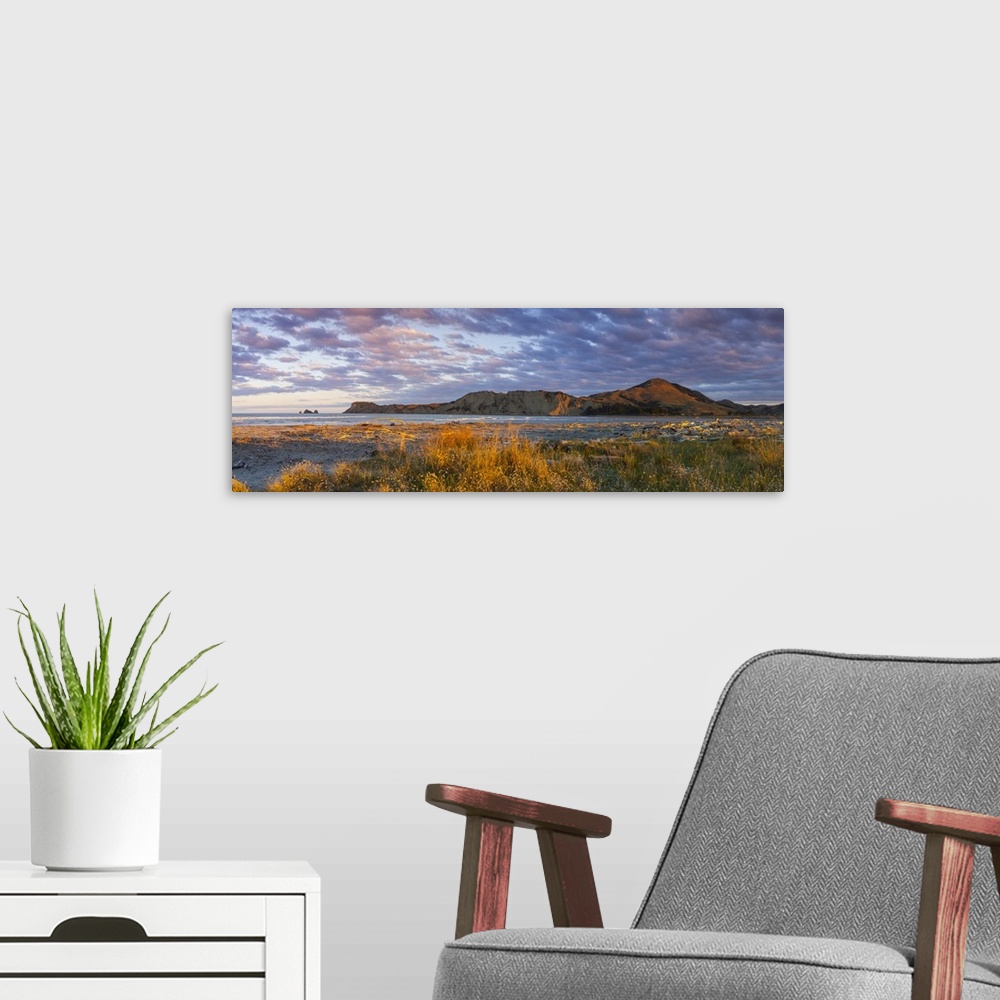 A modern room featuring Dramatic coastal landscape illuminated at sunset, Tologa Bay, East Cape, North Island, New Zealand