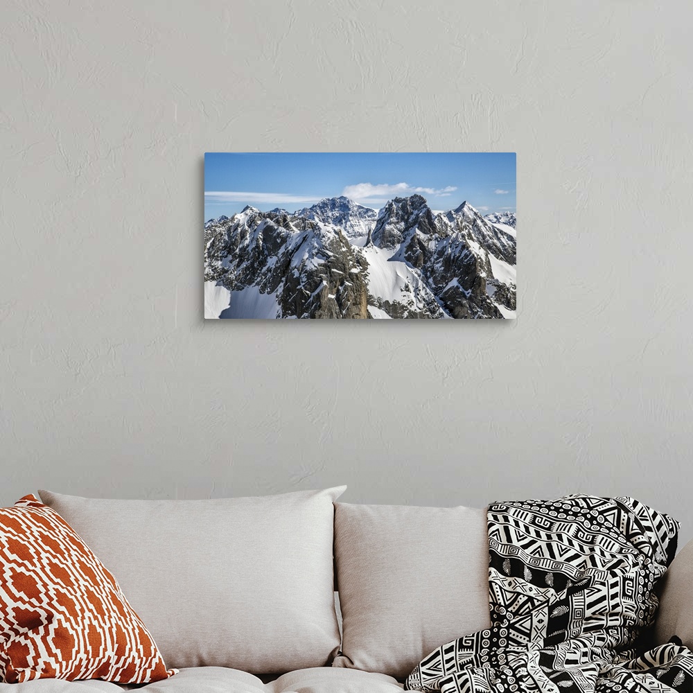 A bohemian room featuring Aerial view of Torrone Peak in winter with Bernina Peak in the background. Valmasino. Lombardy. I...