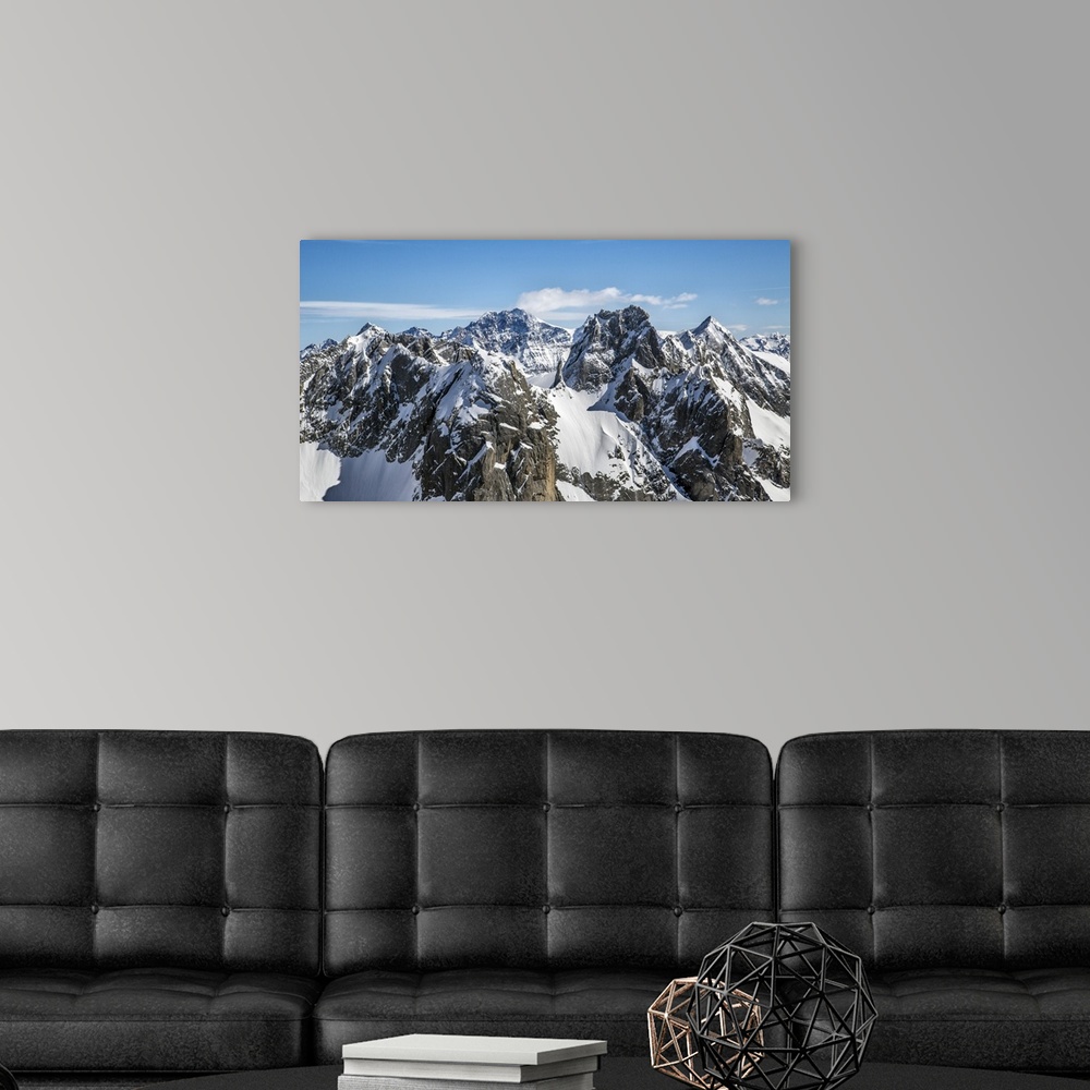 A modern room featuring Aerial view of Torrone Peak in winter with Bernina Peak in the background. Valmasino. Lombardy. I...