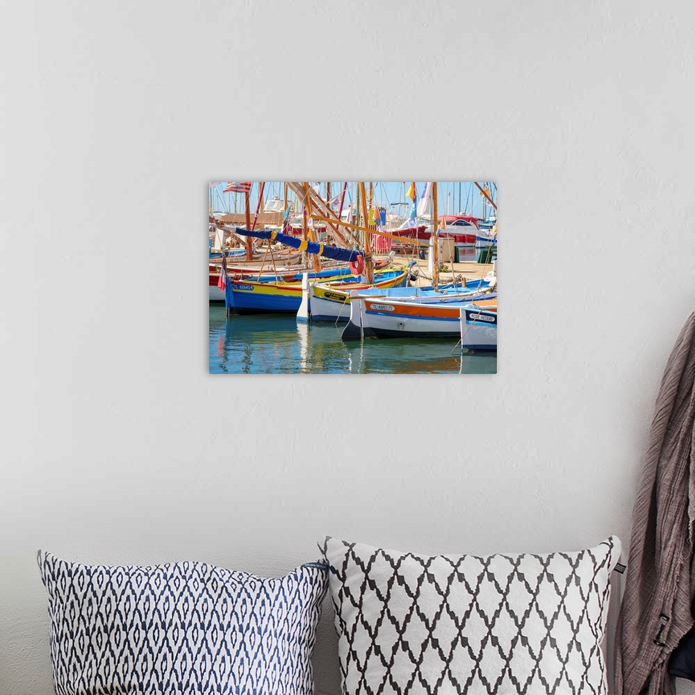 A bohemian room featuring Traditional colorful wooden fishing boat in the port harbor at Sanary-sur-Mer, Var department, Pr...
