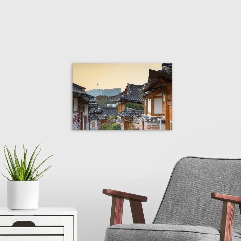 A modern room featuring Traditional houses in Bukchon Hanok village at sunrise, Seoul, South Korea