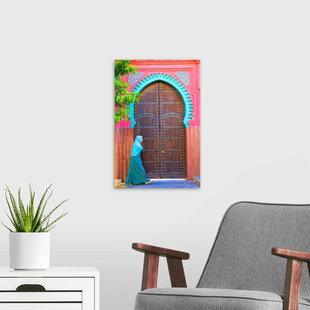A modern room featuring Person Walikng Infront Of Traditional Moroccan Decorative Door, Tangier, Morocco, North Africa.