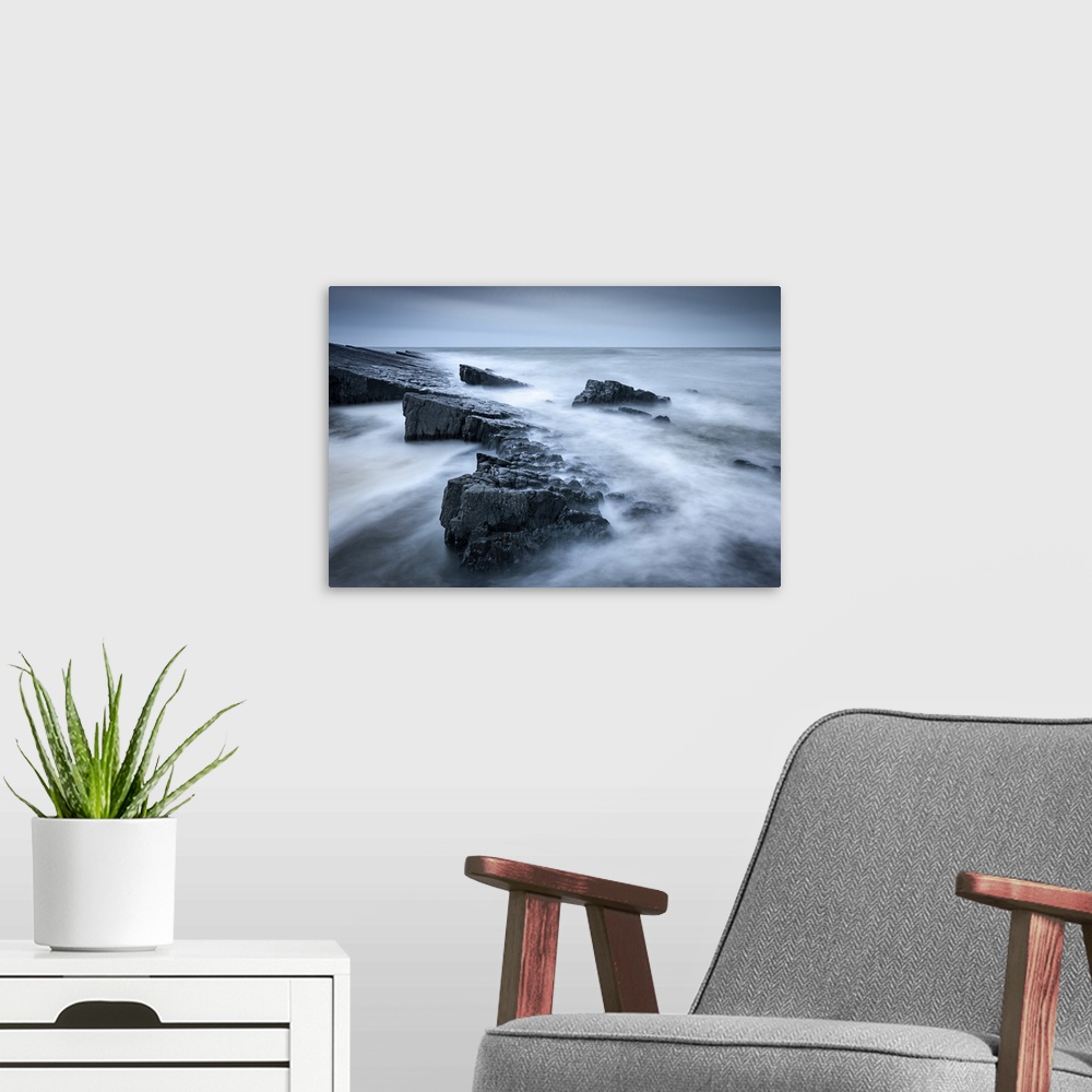 A modern room featuring Twilight on the rocky shores of Speke's Mill Mouth, on the North Devon coast, England. Devon, Eng...