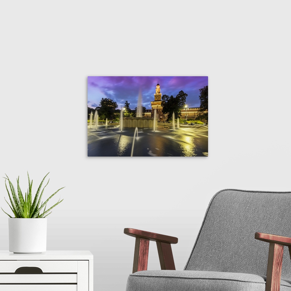 A modern room featuring Twilight view of Sforza Castle or Castello Sforzesco and fountain, Milan, Lombardy, Italy.