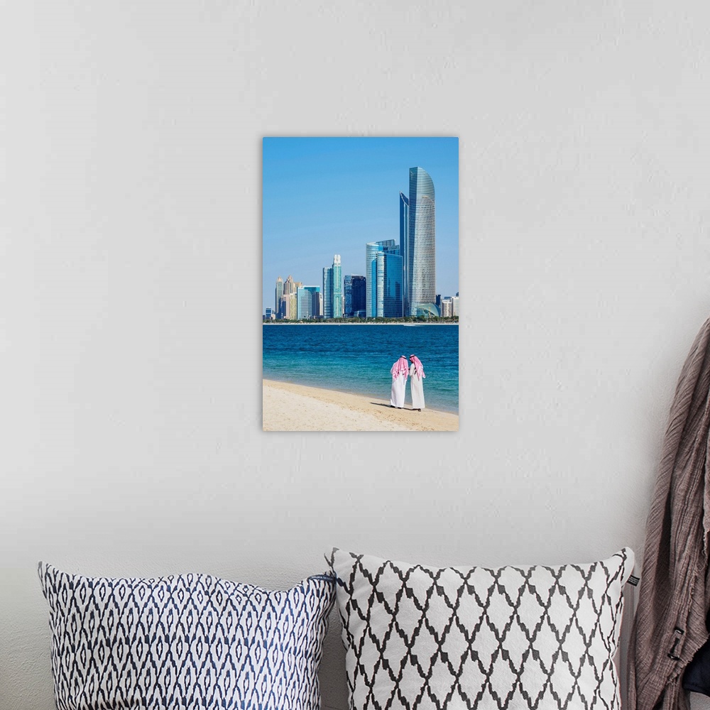 A bohemian room featuring Two Men Wearing Thawb On The Beach And City Center Skyline, Abu Dhabi, United Arab Emirates