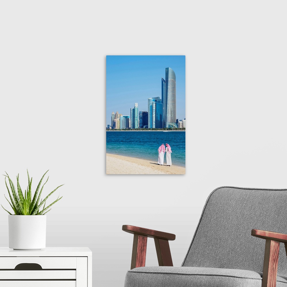 A modern room featuring Two Men Wearing Thawb On The Beach And City Center Skyline, Abu Dhabi, United Arab Emirates