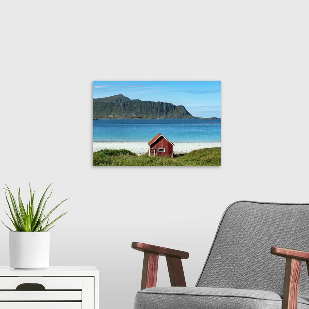 A modern room featuring Typical Red Rorbu On Ramberg Beach, Lofoten Islands, Norway