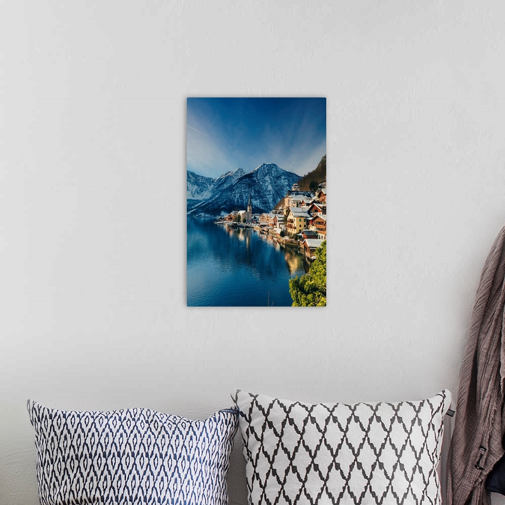 A bohemian room featuring Typical village called Hallstatt con the Hallstatter see at sunrise with the houses reflecting in...