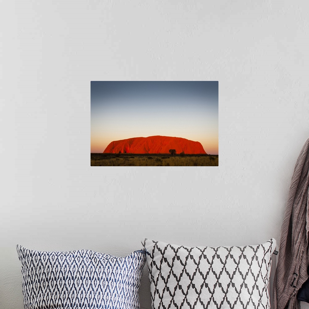 A bohemian room featuring Uluru glowing at dusk. Uluru-Kata Tjuta National Park, Central Australia, Northern Territory, Aus...