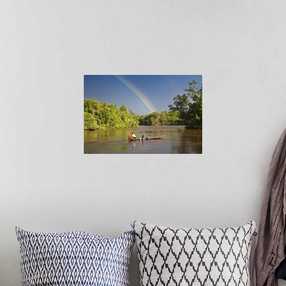 A bohemian room featuring Venezuela, Delta Amacuro, Orinoco Delta, Warao People in boat on Nararina river with rainbow in s...