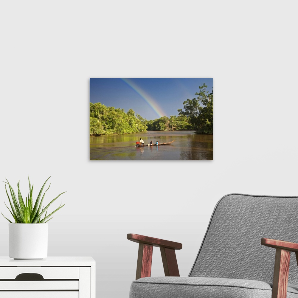 A modern room featuring Venezuela, Delta Amacuro, Orinoco Delta, Warao People in boat on Nararina river with rainbow in s...
