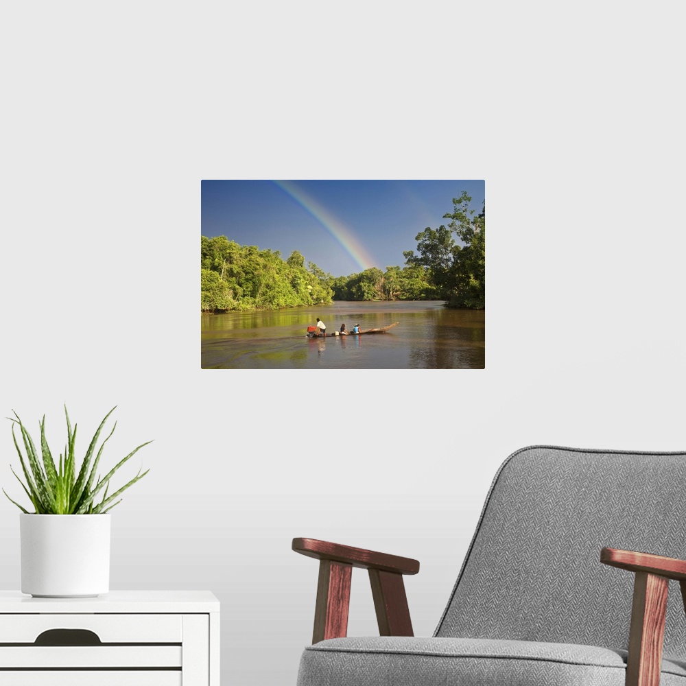 A modern room featuring Venezuela, Delta Amacuro, Orinoco Delta, Warao People in boat on Nararina river with rainbow in s...