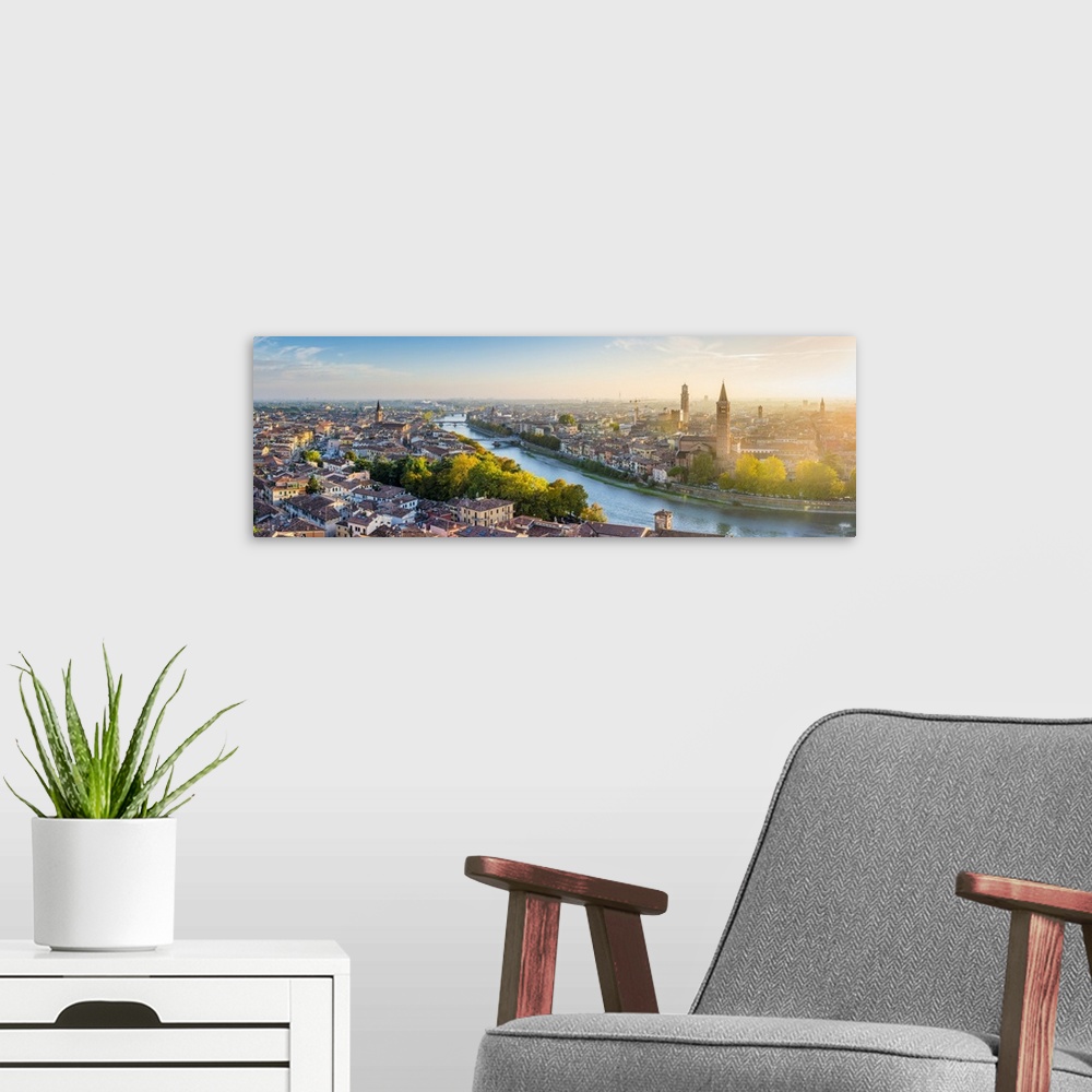 A modern room featuring Verona, Veneto, Italy. High angle panoramic view of the old town and the Adige river at sunset.