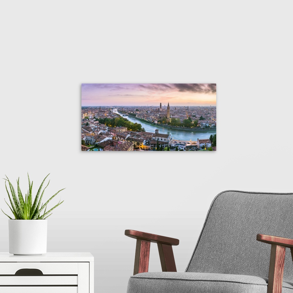 A modern room featuring Verona, Veneto, Italy. High angle panoramic view of the old town and the Adige river at sunset.
