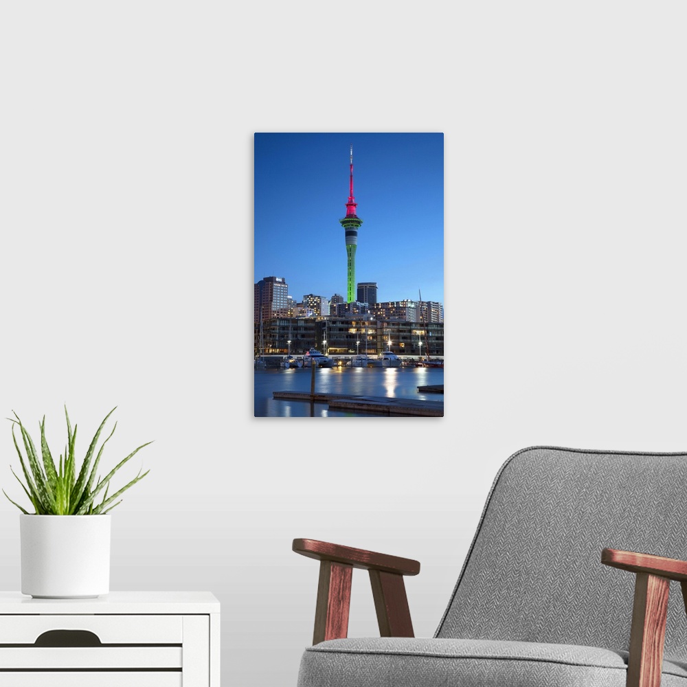A modern room featuring Viaduct Harbour and Sky Tower at dusk, Auckland, North Island, New Zealand