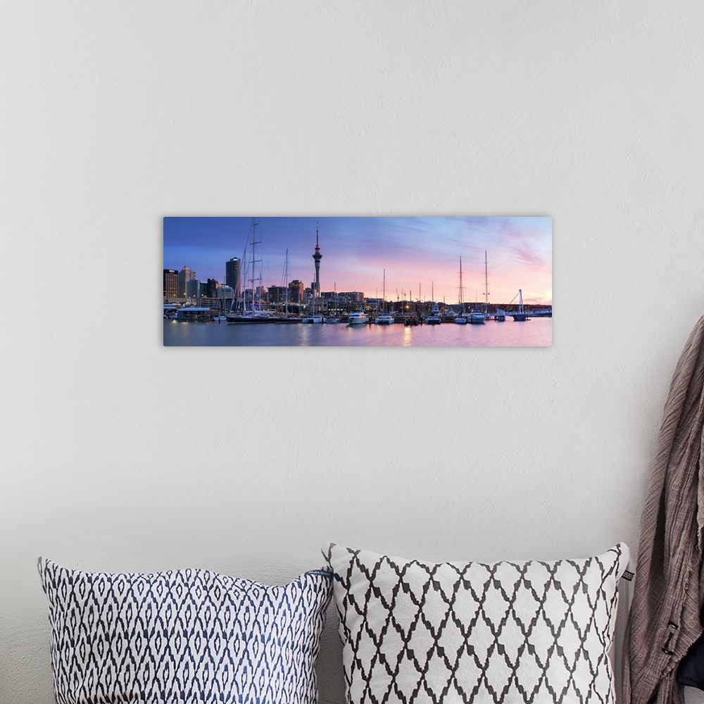 A bohemian room featuring Viaduct Harbour and Sky Tower at sunset, Auckland, North Island, New Zealand