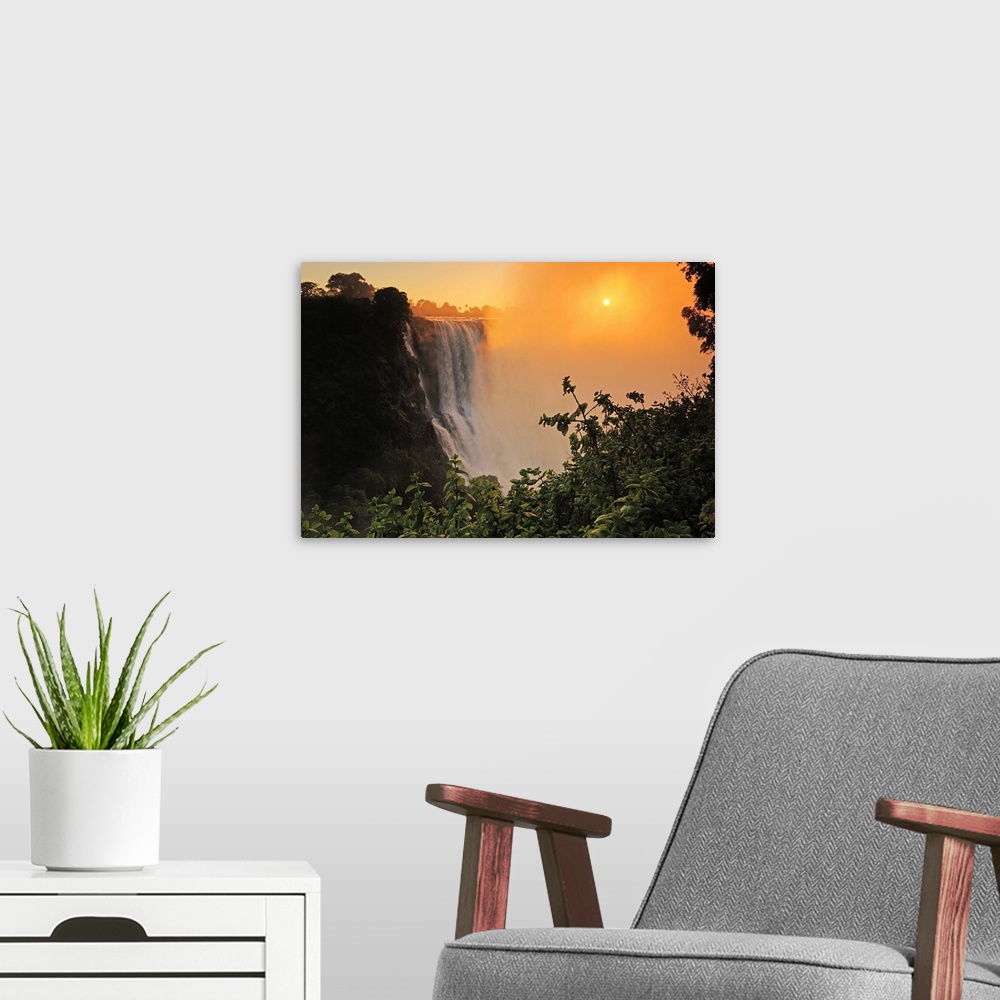 A modern room featuring Victoria Falls at sunrise,  Zambezi River, near Victoria Falls, Zimbabwe, Africa