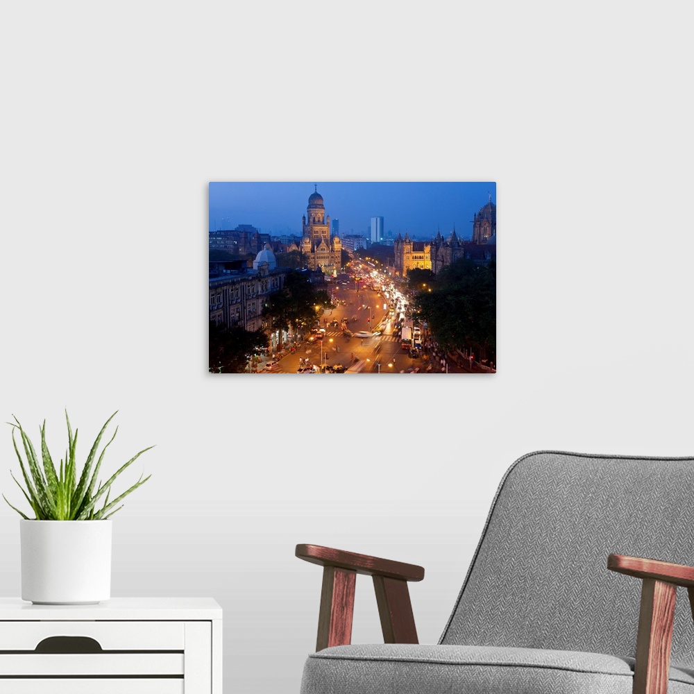 A modern room featuring View over Victoria terminus or Chhatrapati Shivaji terminus (CST) and central Mumbai at dusk Mumb...