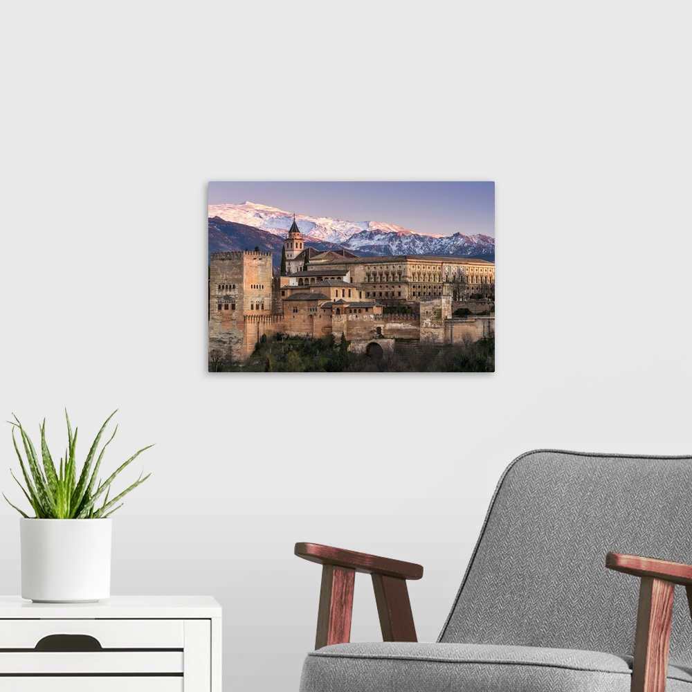 A modern room featuring View at sunset of Alhambra palace with the snowy Sierra Nevada in the background, Granada, Andalu...