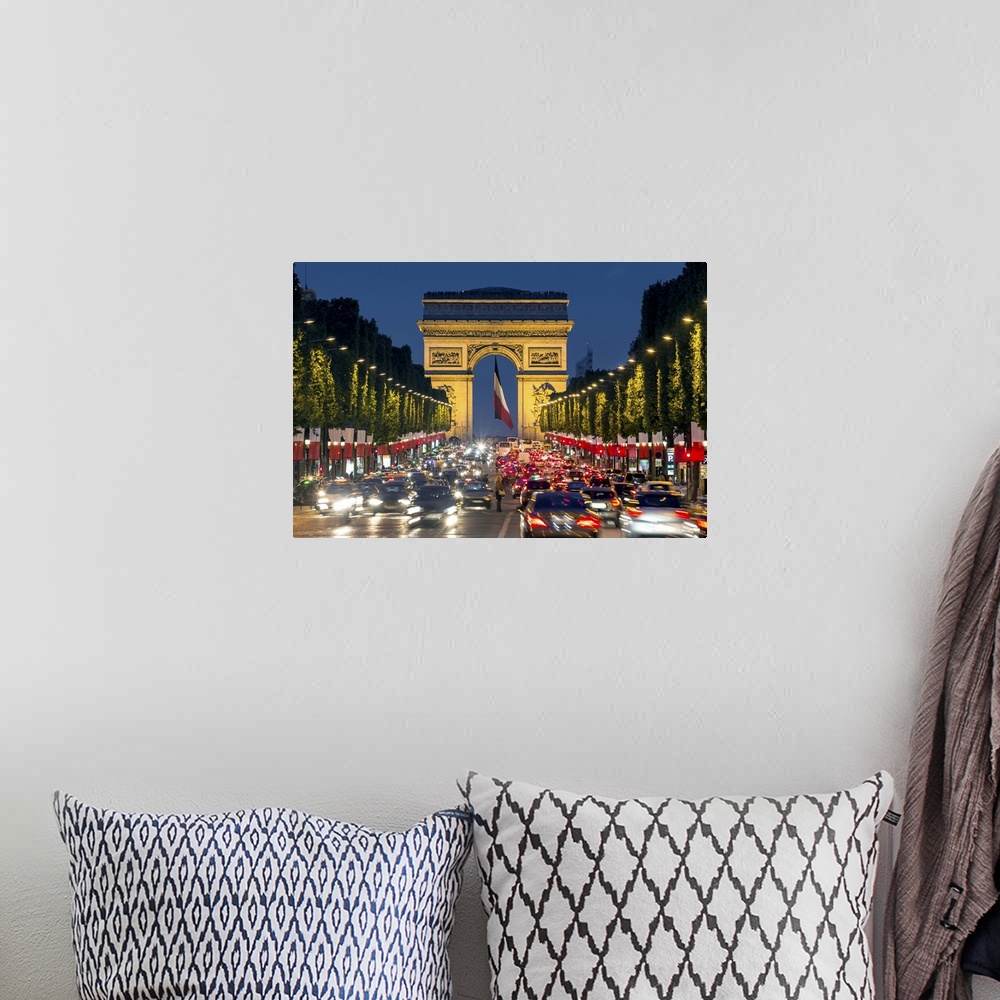 A bohemian room featuring View down the Champs Elysees to the Arc de Triomphe, illuminated at dusk, Paris, France.
