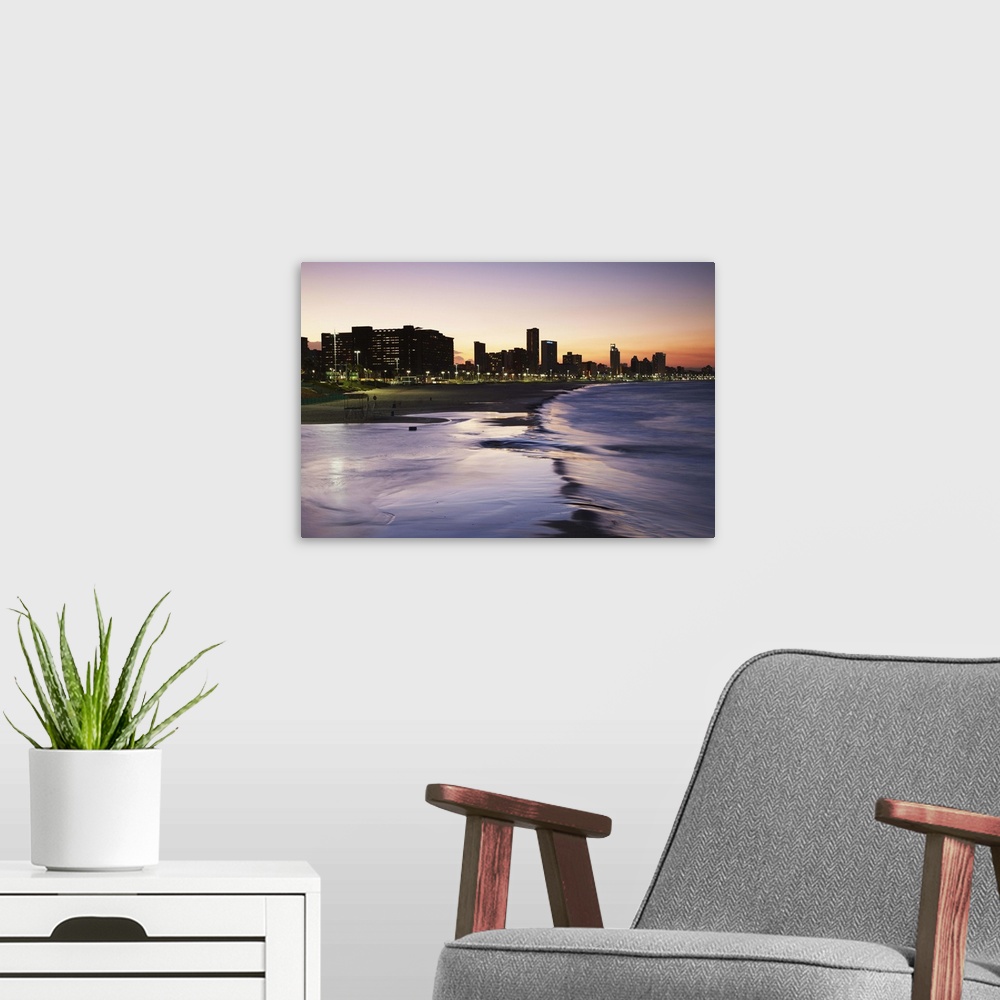 A modern room featuring View of city skyline and beachfront at sunset, Durban, KwaZulu-Natal, South Africa