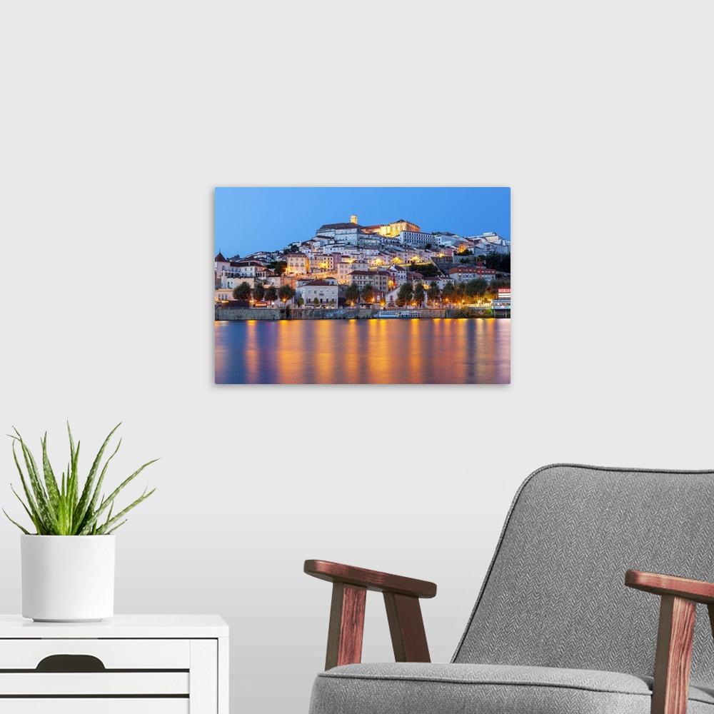 A modern room featuring View of Coimbra ol town and Mondego River at dusk. Coimbra, Coimbra district, Centro Region, Port...