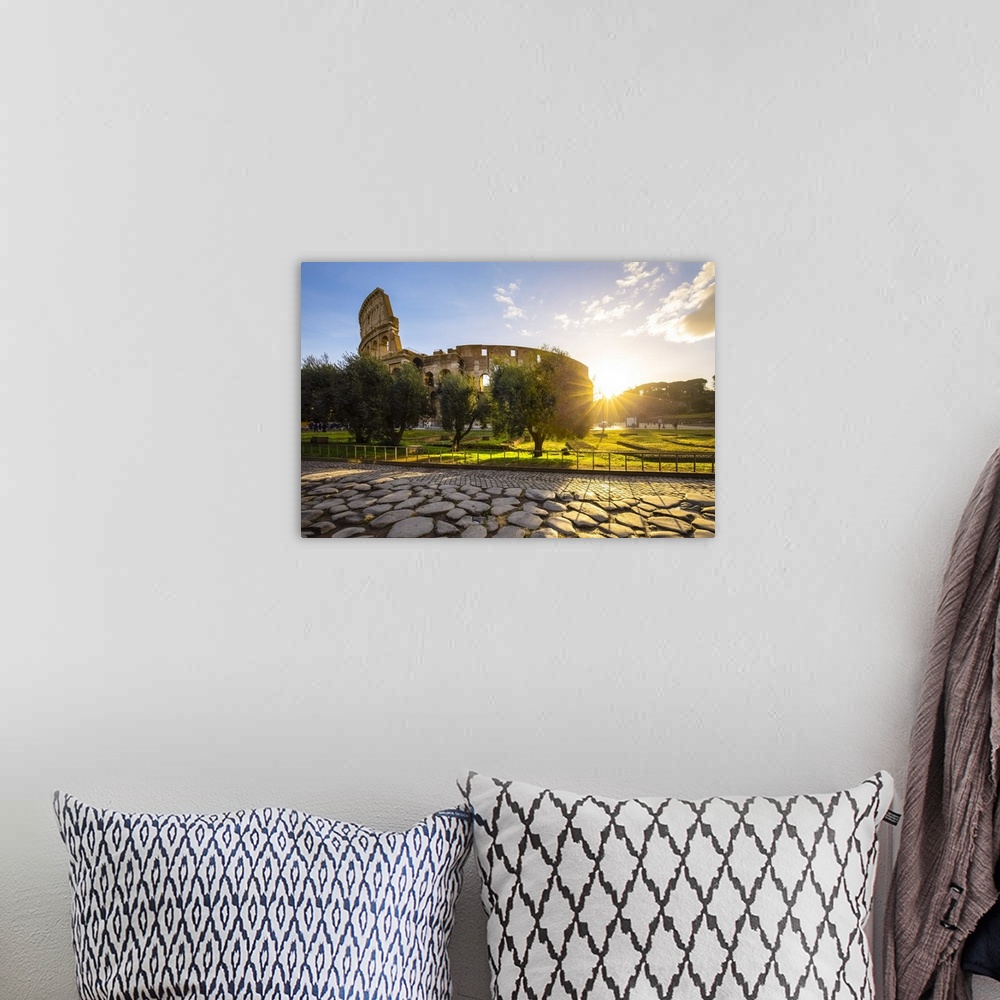 A bohemian room featuring View of the Colosseum during a winter sunrise from the Via Sacra. Rome, Lazio, Italy.