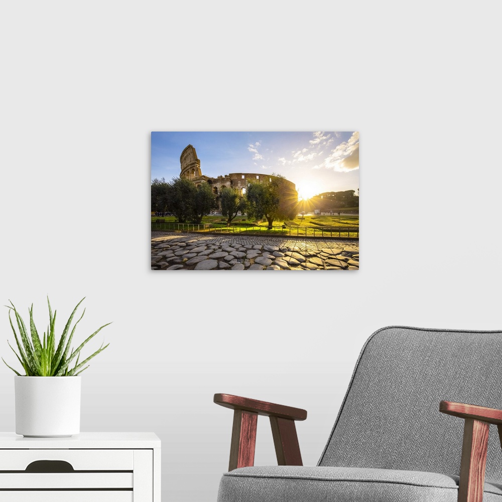 A modern room featuring View of the Colosseum during a winter sunrise from the Via Sacra. Rome, Lazio, Italy.