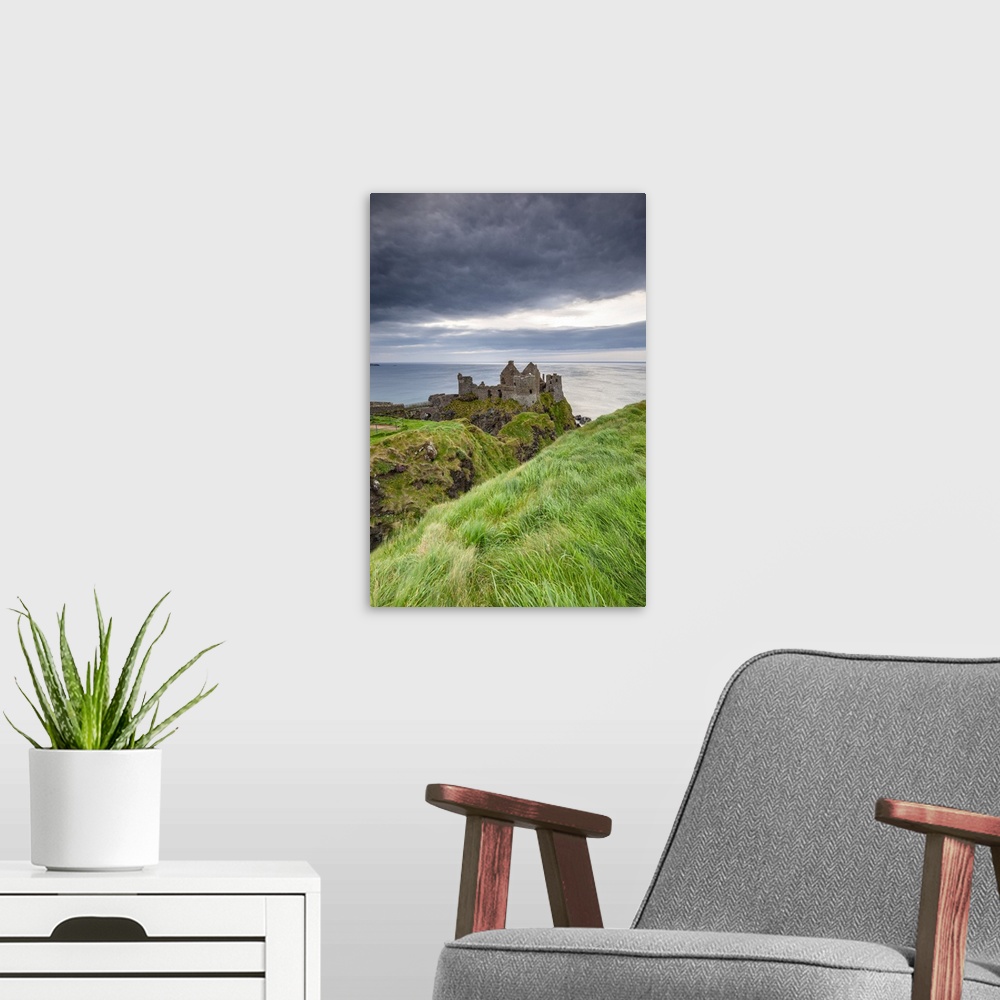 A modern room featuring View of the ruins of the Dunluce Castle. Bushmills, County Antrim, Ulster region, Northern Irelan...