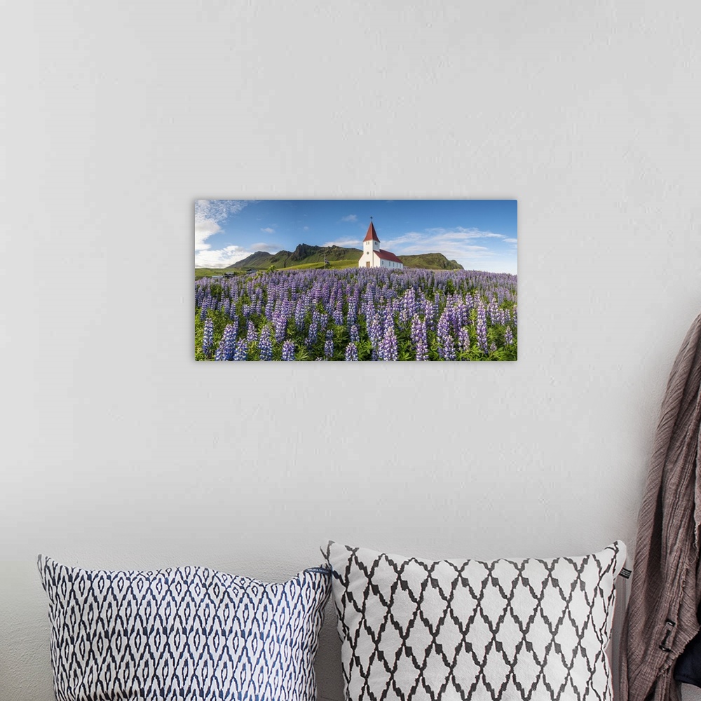 A bohemian room featuring Vik i Myrdal, Southern Iceland. Fields of lupins in bloom and the town church.
