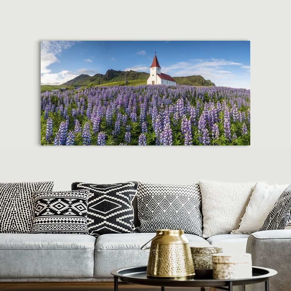 A bohemian room featuring Vik i Myrdal, Southern Iceland. Fields of lupins in bloom and the town church.