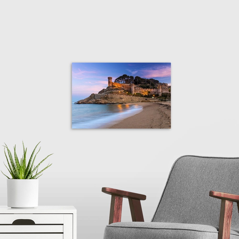 A modern room featuring View at dusk of Vila Vella, the medieval old town of Tossa del Mar, Costa Brava, Catalonia, Spain