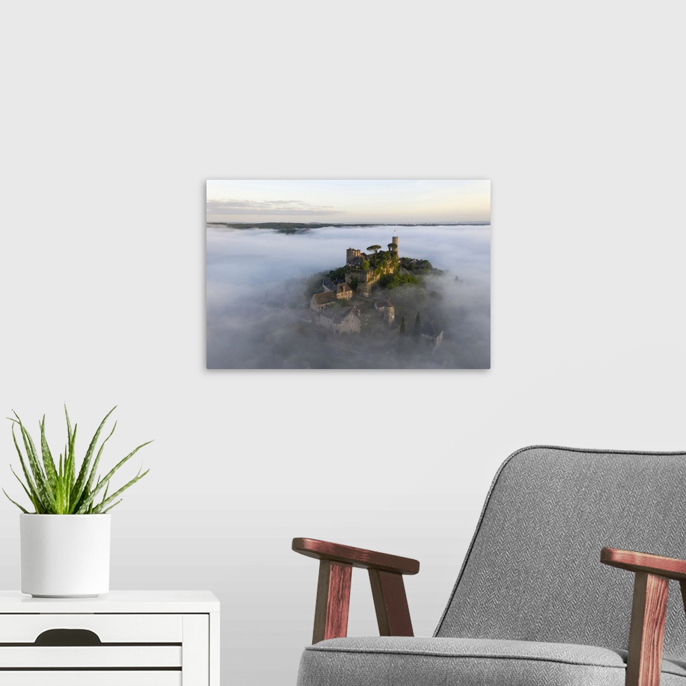 A modern room featuring An aerial view of the hilltop village of Turenne at sunrise surrounded by mist, Correze, Limousin...