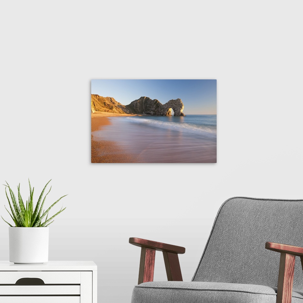 A modern room featuring Waves sweeping onto the deserted beach at Durdle Door, Dorset, England. Winter