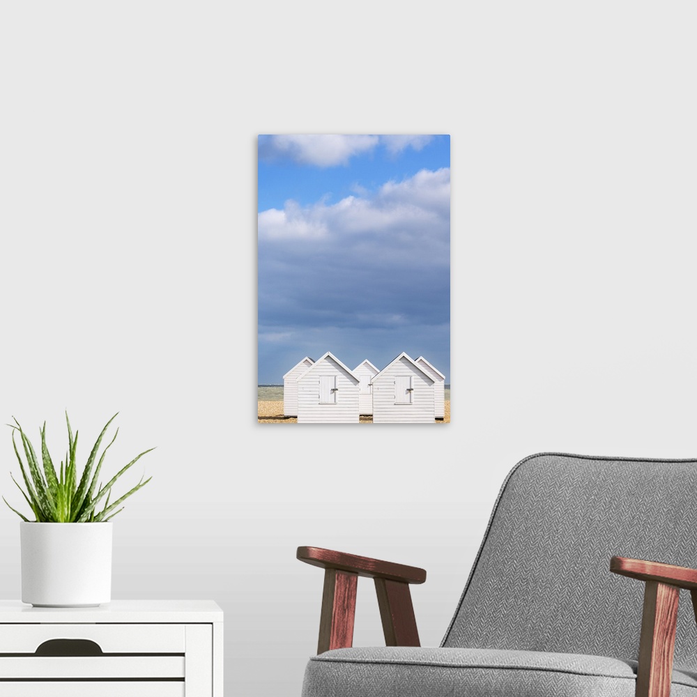 A modern room featuring White beach huts ion a beach in Walmer, Kent, England