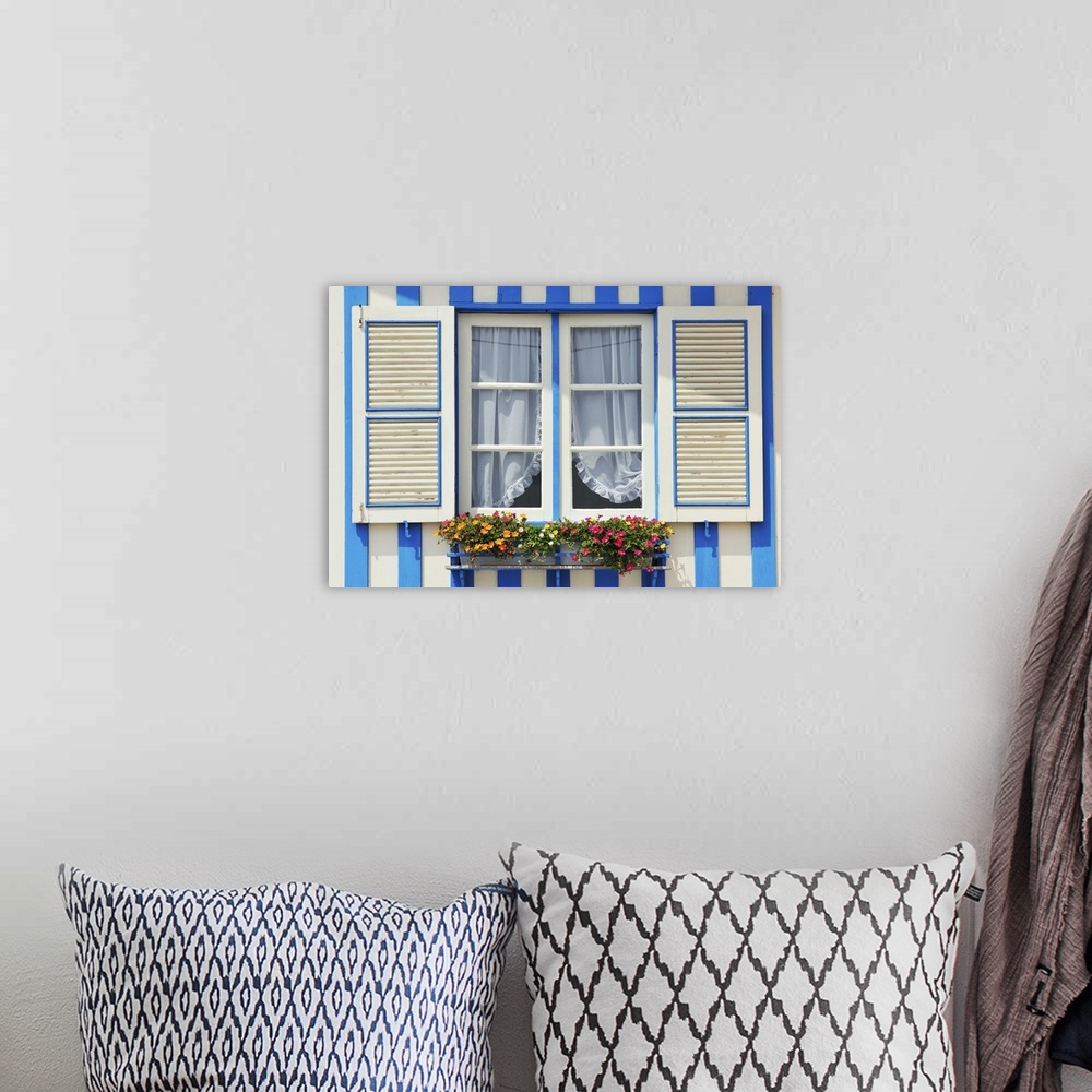 A bohemian room featuring Window of a traditional striped painted house in the little seaside village of Costa Nova, Portugal