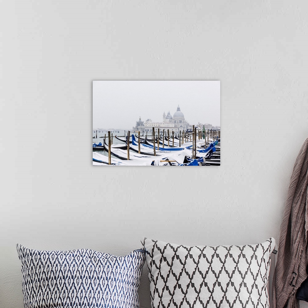A bohemian room featuring Winter snowfall in the city of Venice, gondolas covered by snow and in the background the church ...