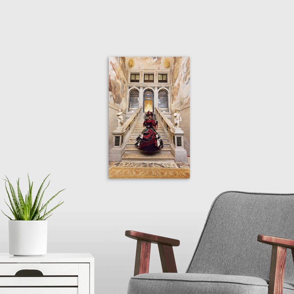A modern room featuring Woman in costume standing on staircase in Ca Segredo palace during Carnival, Venice, Veneto, Italy