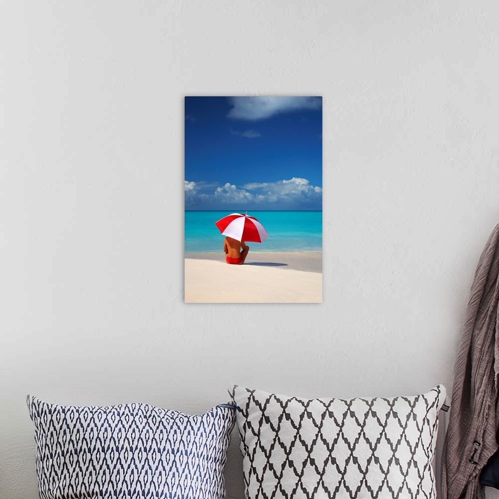 A bohemian room featuring Woman Sitting On Beach With Red And White Umbrella, Barbuda, Caribbean, West Indies